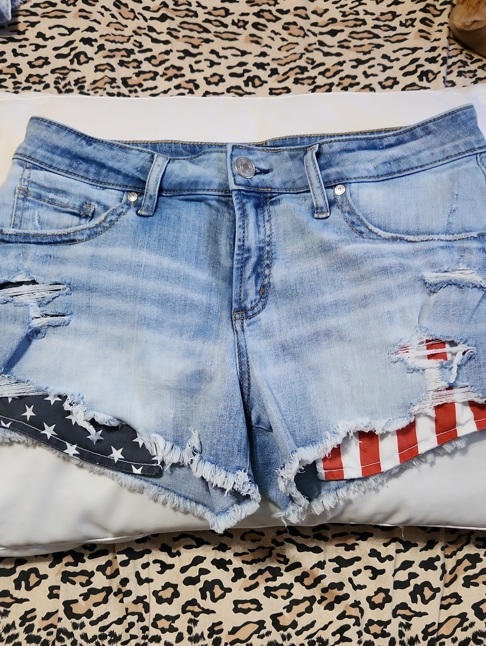Silver Jeans Light Blue Distressed Denim Shorts with Flag Accents